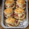 Golden, buttery biscuit sandwiches stuffed with deli ham and gooey melted Swiss — baked all together in one pan
