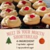 A batch of soft, buttery melt-in-your-mouth shortbread cookies, piped into delicate swirls and topped with bright red candied cherries for a festive finish