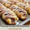 Golden-brown cinnamon roll bread twists arranged on a baking sheet, filled with cinnamon-sugar swirls and finished with a generous drizzle of white vanilla glaze.