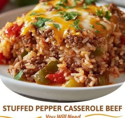 A hearty slice of stuffed pepper beef casserole loaded with seasoned ground beef, tender rice, colorful bell peppers, tomatoes, and melted cheddar cheese, finished with fresh parsley.