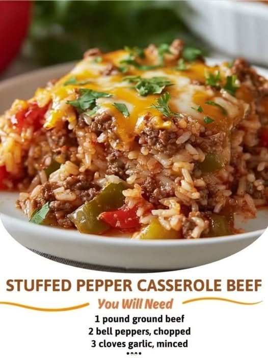 A hearty slice of stuffed pepper beef casserole loaded with seasoned ground beef, tender rice, colorful bell peppers, tomatoes, and melted cheddar cheese, finished with fresh parsley.