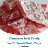 A pile of glossy red cinnamon rock candy pieces dusted generously with powdered sugar, with a crisp, glass-like texture and a sweet, spicy cinnamon flavor