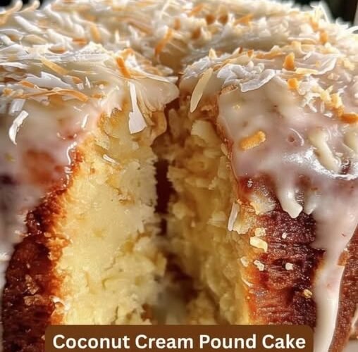 A moist coconut cream pound cake with a tender, buttery crumb, covered in creamy coconut glaze and generously sprinkled with shredded coconut for a rich, tropical finish.