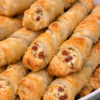 Crisp, flaky puff pastry twisted around a warm, savory ham and cheddar filling — a 1965 classic that empties the platter every time.