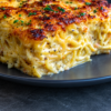 Cream cheese melted straight into al dente pasta with sour cream, mozzarella, and Parmesan, baked until the top is bubbling and golden. One pot, one dish, forty minutes, about $1.60 a serving.