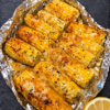 Grilled corn cobs slathered in creamy, tangy crema with salty cotija cheese, chili, cilantro, and a bright squeeze of lime. Authentic street-food energy for your backyard or kitchen — naturally gluten-free and vegetarian.