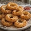 Golden-brown crispy onion rings coated in crunchy breadcrumbs, filled with gooey melted mozzarella, and served with marinara dipping sauce.