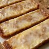 Chewy, honey-warm German spice bars with a glossy orange glaze. A one-pan shortcut to the classic Christmas treat — and at their absolute best 1–2 weeks after baking.