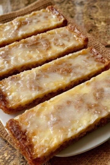 Chewy, honey-warm German spice bars with a glossy orange glaze. A one-pan shortcut to the classic Christmas treat — and at their absolute best 1–2 weeks after baking.