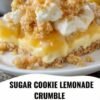A slice of sugar cookie lemonade crumble topped with creamy lemon filling, whipped cream, and golden buttery cookie crumbs, with a bright lemon in the background.