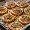 Golden-baked potato rounds topped with gooey melted cheddar, crispy bacon crumbles, and fresh green onions—a deliciously loaded comfort-food appetizer.