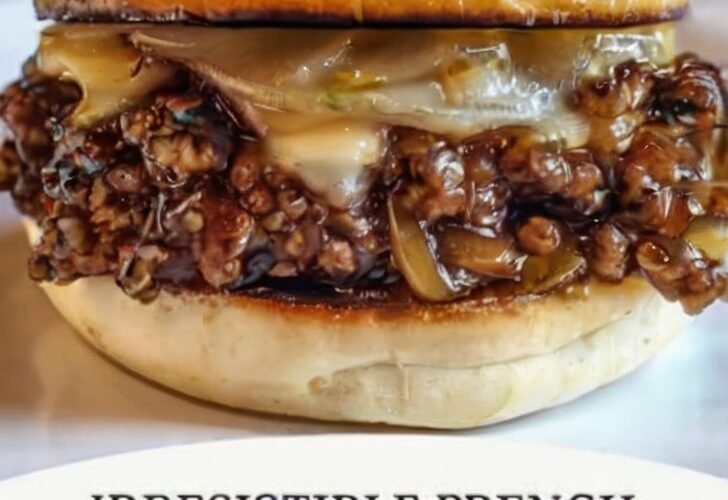 A glossy French onion beef sloppy joe on a toasted brioche bun, packed with seasoned ground beef, caramelized onions, and melted cheese.