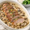 Sliced tender pork tenderloin served over a creamy mushroom and onion sauce, garnished with fresh parsley and paired with fluffy white rice and steamed broccoli.