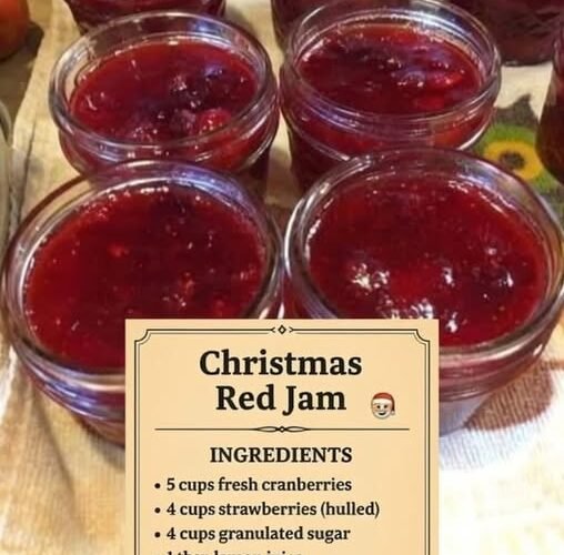 Several small jars of glossy, deep-red Christmas jam made with fresh cranberries, strawberries, sugar, and lemon juice, with visible pieces of fruit for a rustic homemade texture. littlehealthylife.com