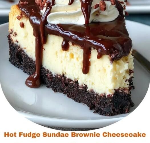 A decadent slice of Hot Fudge Sundae Brownie Cheesecake featuring a rich, fudgy brownie base, a thick layer of creamy vanilla cheesecake, glossy chocolate fudge dripping down the sides, and fluffy whipped cream topped with chocolate candies.