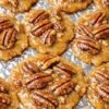 Sweet, buttery Pecan Praline Cookies topped with crunchy pecan halves and a glossy caramel-like glaze. 🥜🍪 These golden, chewy treats combine rich brown-sugar sweetness with toasted pecans for an irresistible old-fashioned Southern dessert!