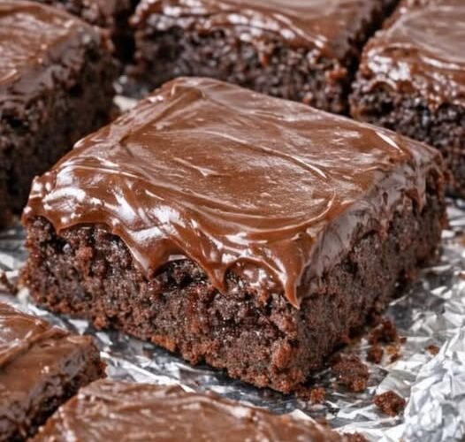 Rich, fudgy chocolate brownies topped with a thick layer of glossy, silky chocolate frosting. 🍫 These old-fashioned treats are wonderfully moist, deeply chocolatey, and perfect for sharing with family or enjoying with a glass of cold milk!