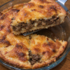 Golden, crispy Ground Beef and Cornbread Pie with a savory, seasoned beef filling nestled between layers of tender cornbread. 🥧 The beautifully browned top and hearty meat center make this old-fashioned comfort food perfect for a satisfying family dinner!