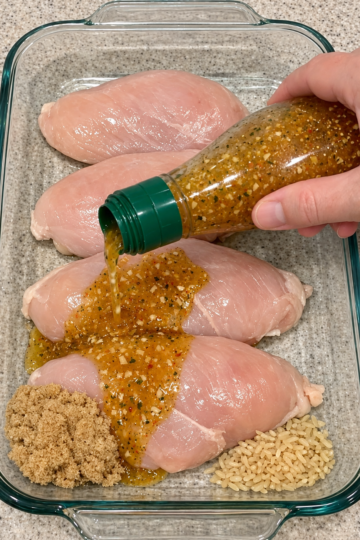 Pour zesty Italian dressing over raw whole chicken breasts in the glass casserole dish with 2 other ingredients and your family will beg for more