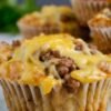 Golden-brown savory cheeseburger muffins packed with seasoned ground beef and topped with gooey melted cheddar, with a tender, flavorful muffin base and crispy edges. muffinmama.com