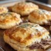 Golden, flaky biscuits stuffed with tender shredded beef and gooey melted cheese, baked until beautifully browned and finished with a sprinkle of fresh herbs